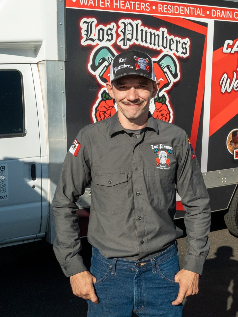 A Los Plumbers technician with the company fleet in Mesa, Arizona