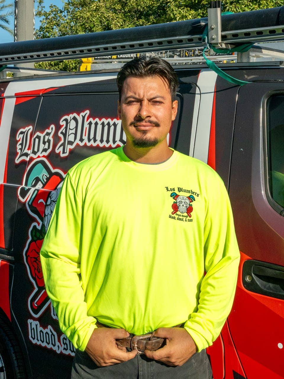 A Los Plumbers technician with the company fleet in Mesa, Arizona