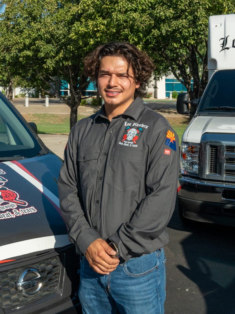A Los Plumbers technician with the company fleet in Mesa, Arizona