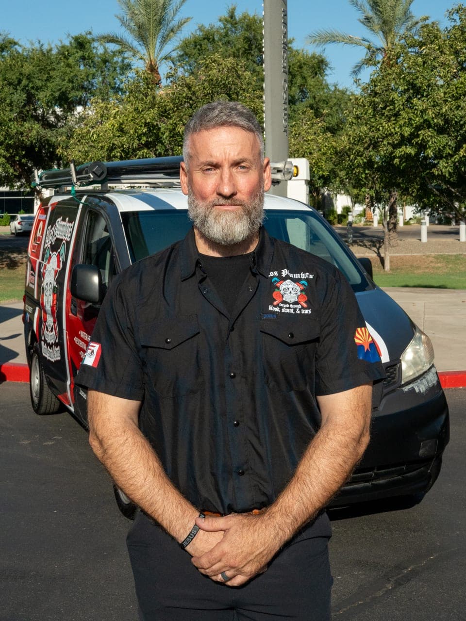 A Los Plumbers technician with the company fleet in Mesa, Arizona