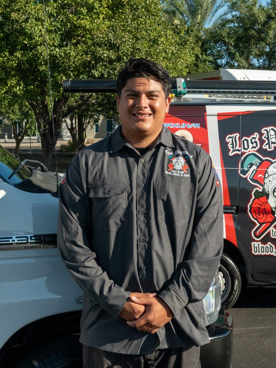 A Los Plumbers technician with the company fleet in Mesa, Arizona