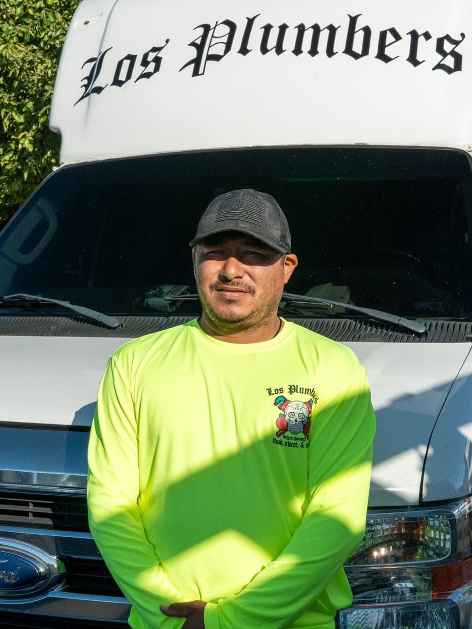 A Los Plumbers technician with the company fleet in Mesa, Arizona