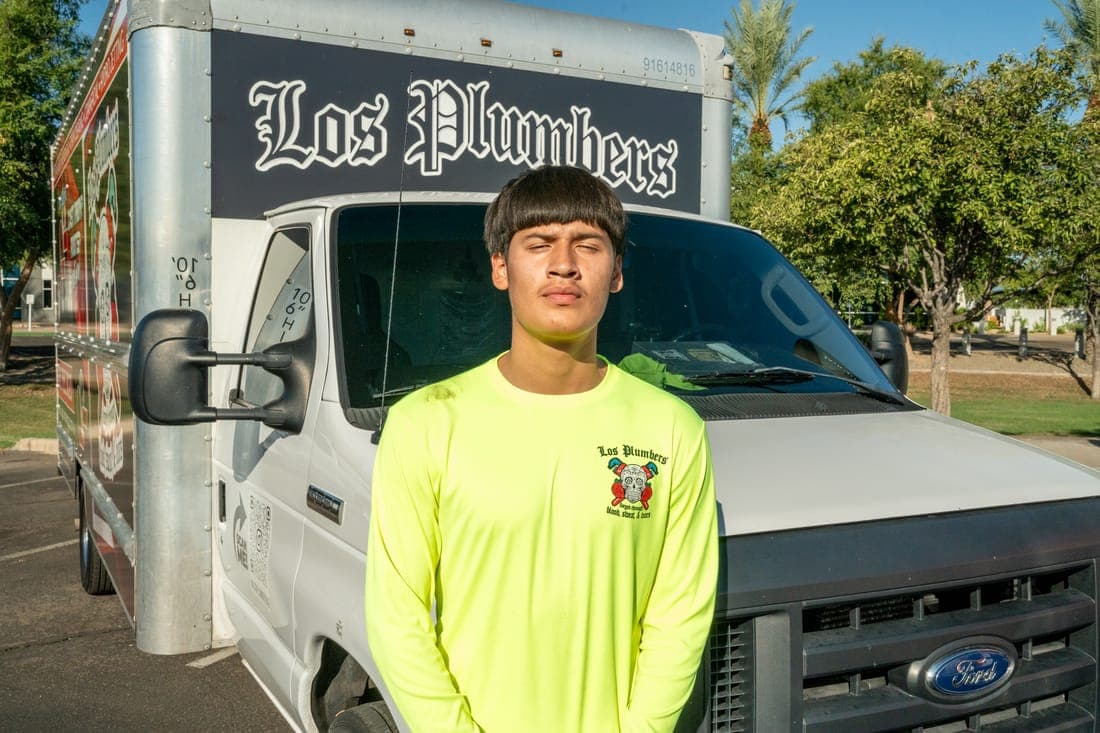 A Los Plumbers technician with the company fleet in Mesa, Arizona