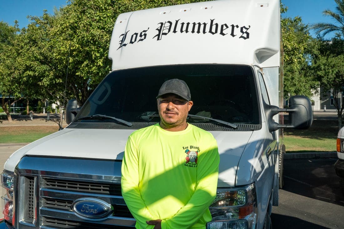 A Los Plumbers technician with the company fleet in Mesa, Arizona