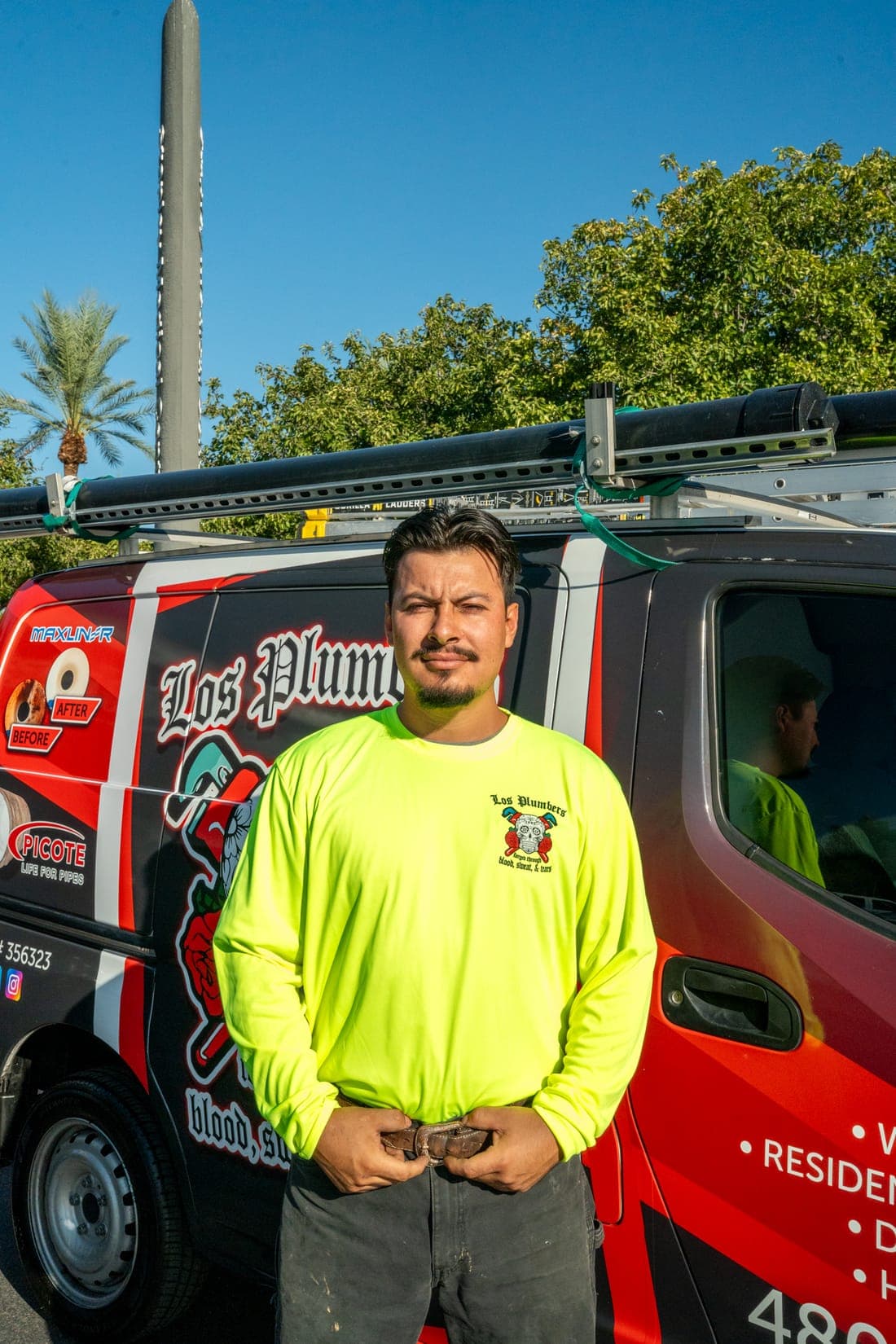 A Los Plumbers technician with the company fleet in Mesa, Arizona