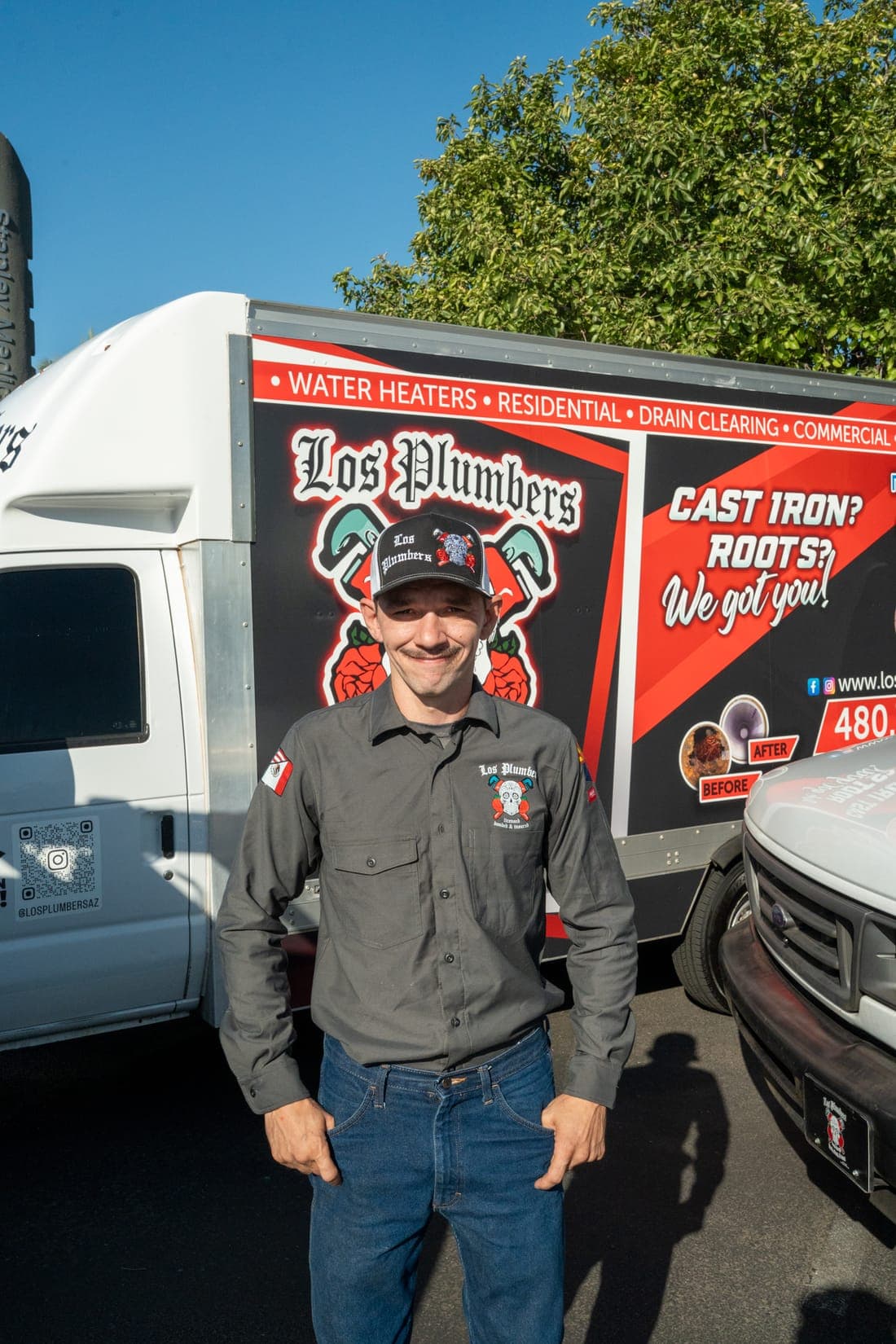 A Los Plumbers technician with the company fleet in Mesa, Arizona