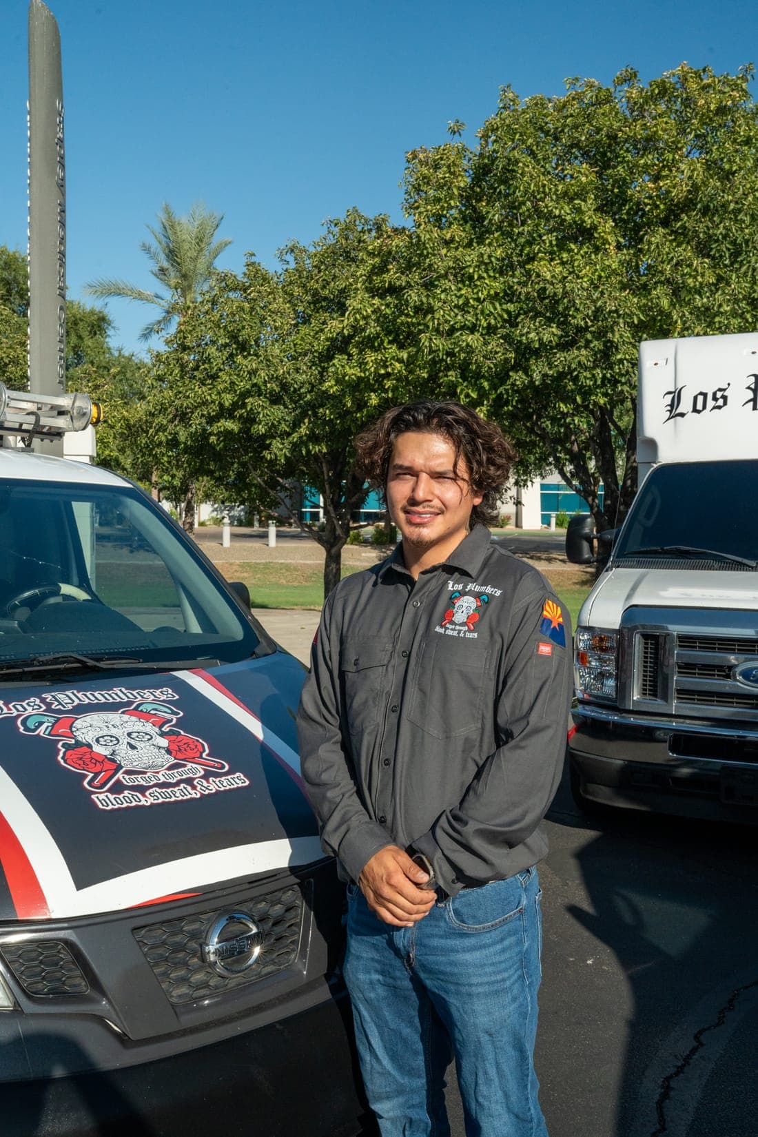 A Los Plumbers technician with the company fleet in Mesa, Arizona