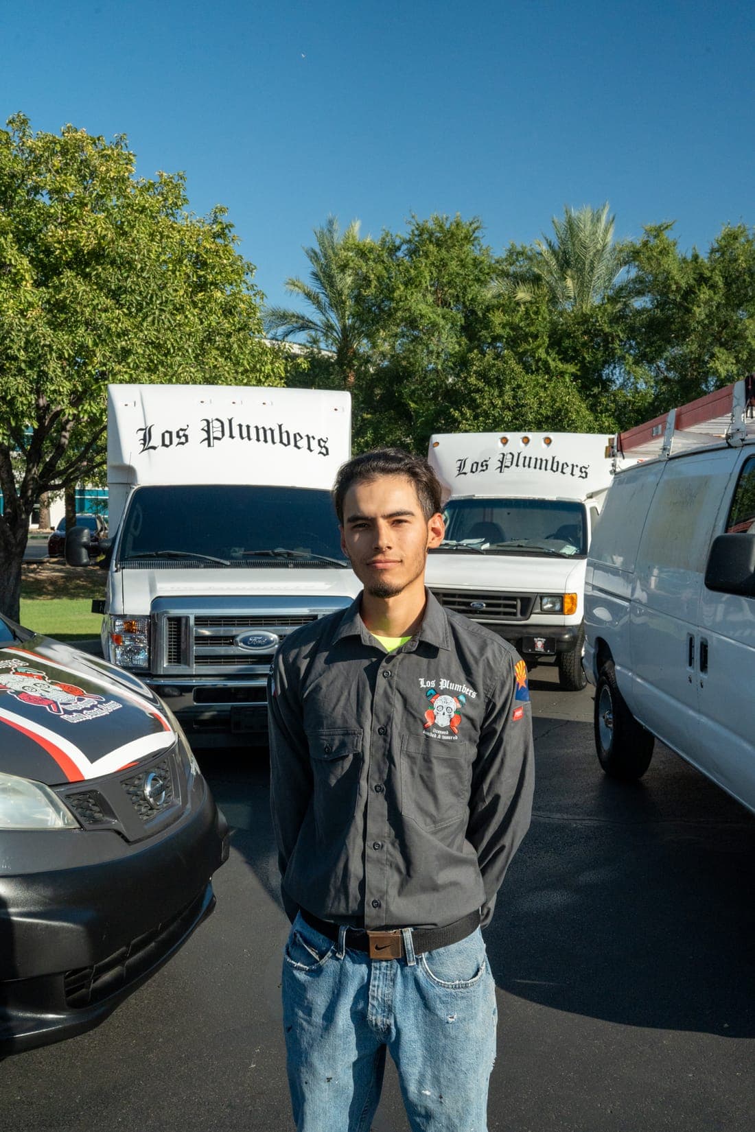 A Los Plumbers technician with the company fleet in Mesa, Arizona