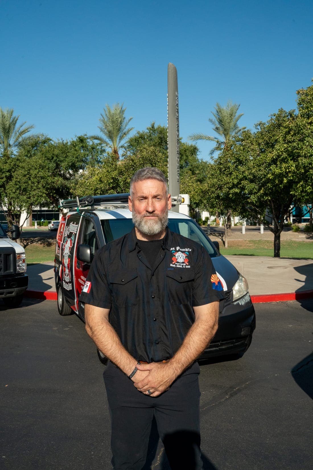 A Los Plumbers technician with the company fleet in Mesa, Arizona