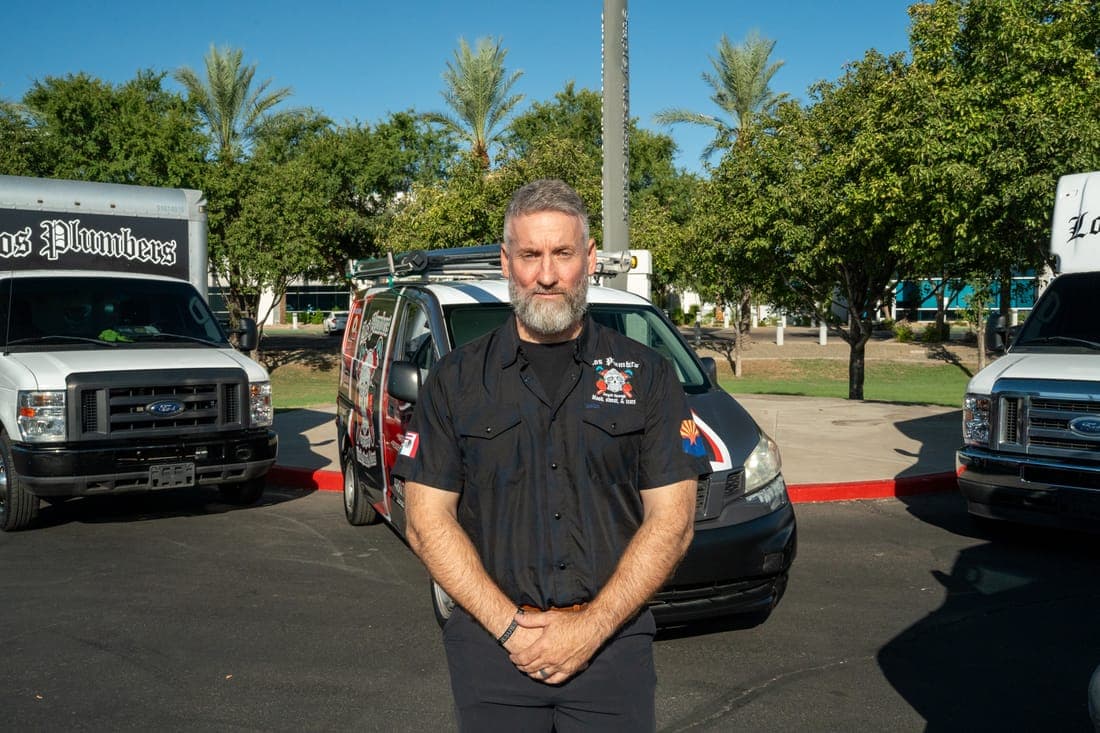 A Los Plumbers technician with the company fleet in Mesa, Arizona