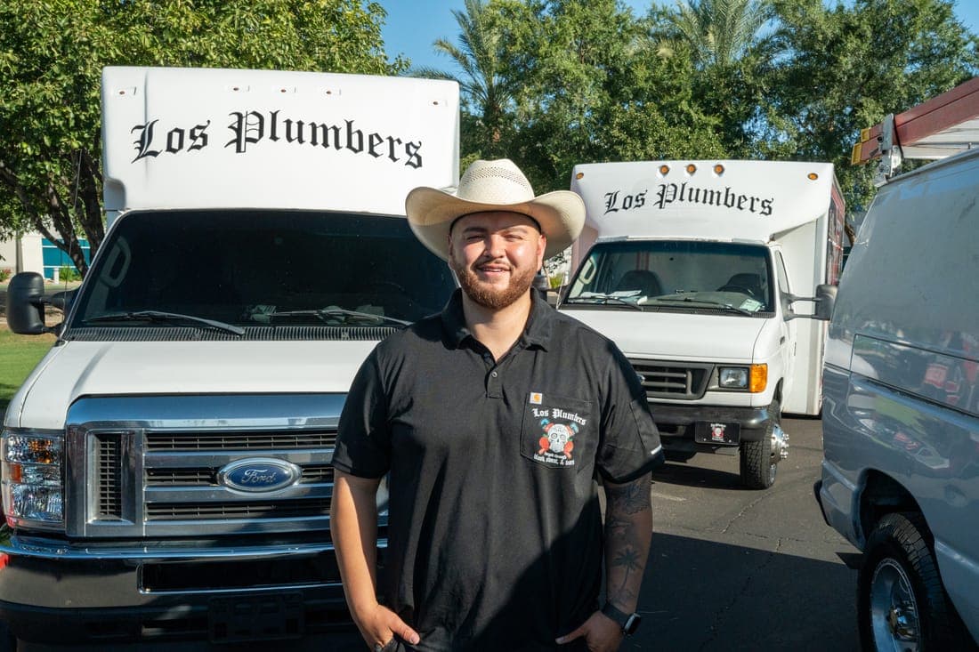 A Los Plumbers technician with the company fleet in Mesa, Arizona