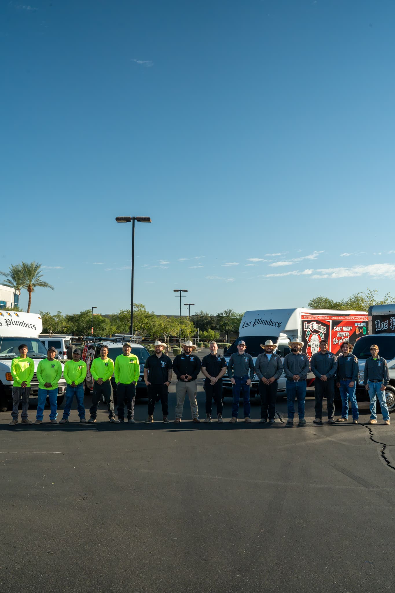 La cuadrilla de Los Plumbers formada junto a la flota de la compañía en Mesa, Arizona